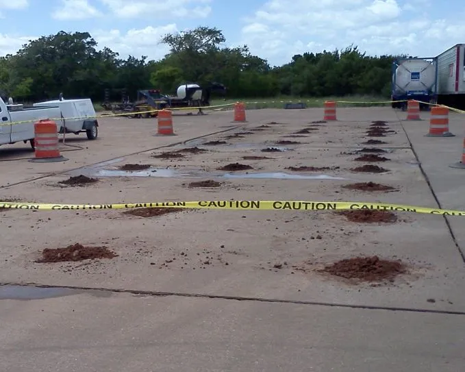 Construction site with caution tape and cones.