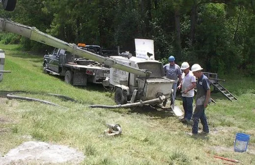 Construction workers operating machinery outdoors.