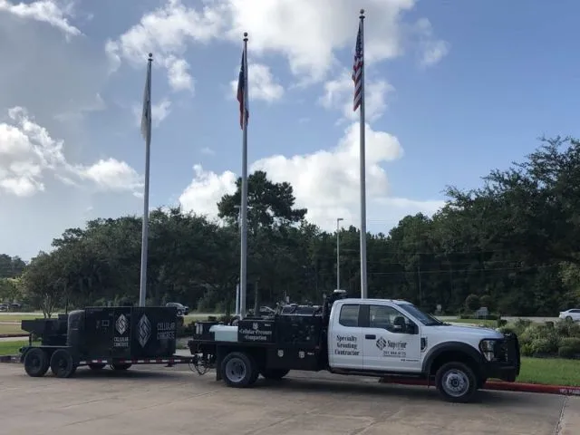 Utility truck with trailer and American flags.