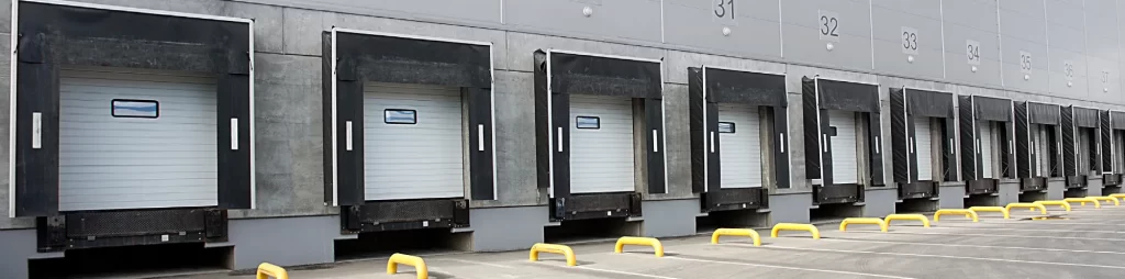 Row of empty warehouse loading docks.