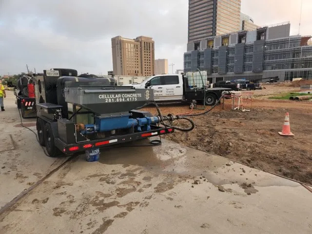 Cellular concrete pumping truck at construction site.