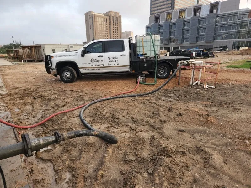 Commercial truck on construction site near building development.