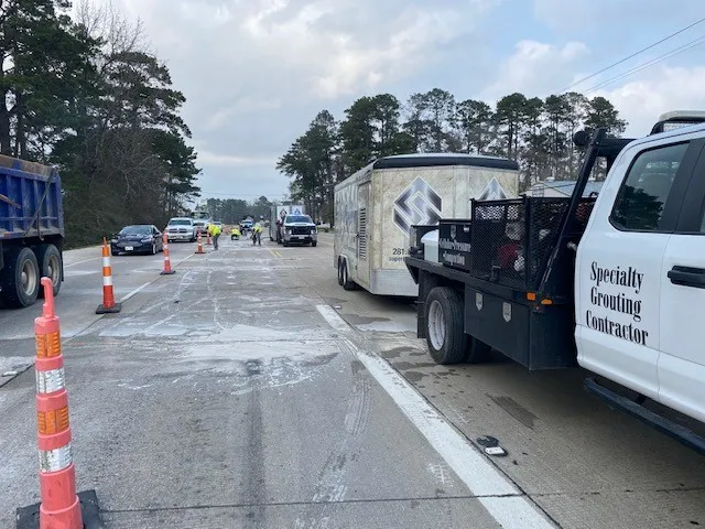 Road construction with vehicles and workers ahead.