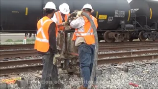Railroad workers inspecting track equipment.